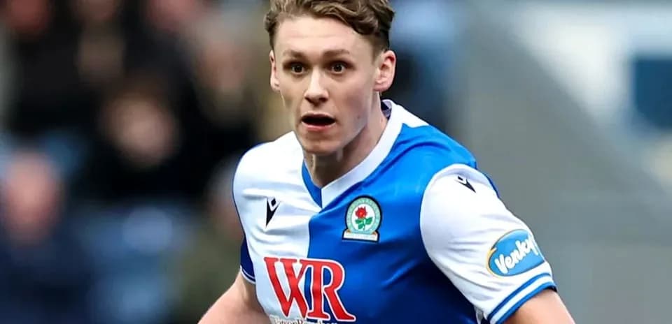 Player in Blackburn Rovers jersey running on field