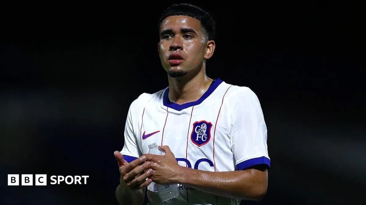 Player in white jersey holding a water bottle