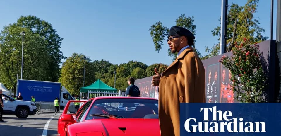 Person standing next to a red sports car outdoors