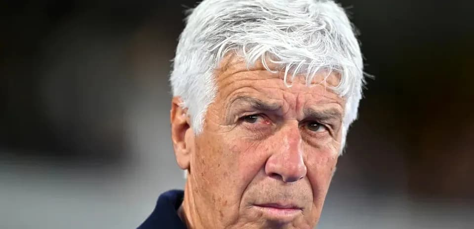 Coach with white hair looking intently at the camera