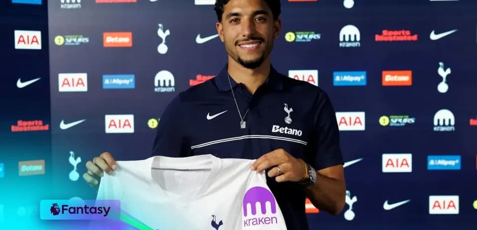 Player holding Tottenham jersey at signing event