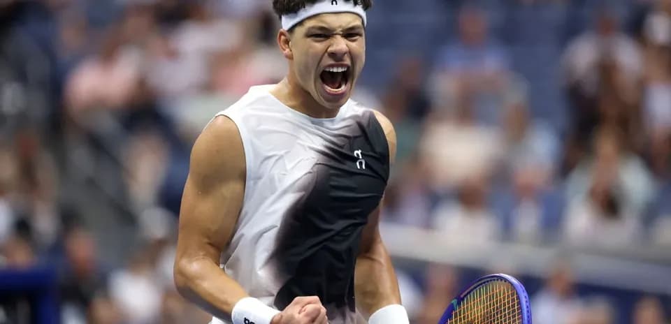 Tennis player celebrating with racket during match