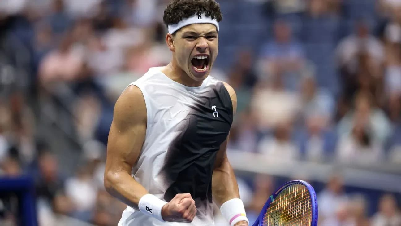 Tennis player celebrating with racket during match