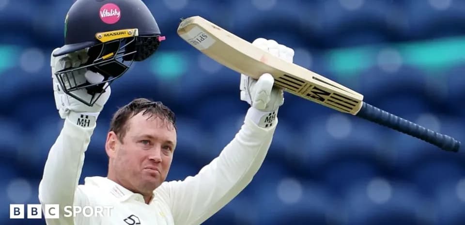 Batsman celebrating with helmet and bat raised