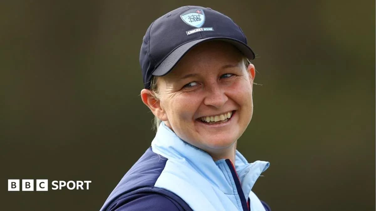 Smiling woman wearing a cricket cap outdoors