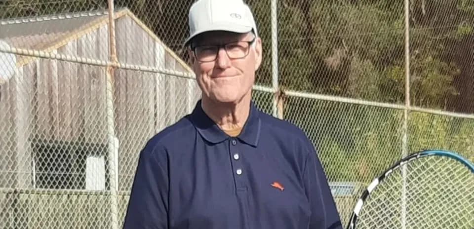 Man holding tennis racket on court