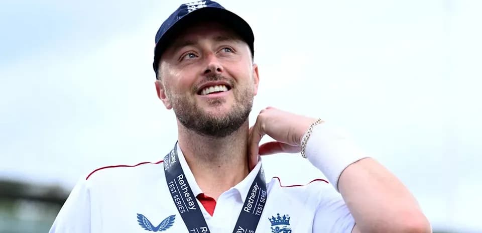 Cricketer wearing England jersey with medal around neck