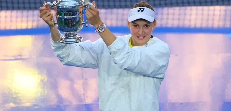 Player holding trophy after winning tennis match