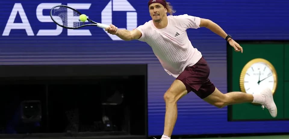 Player lunging to hit a tennis ball during match