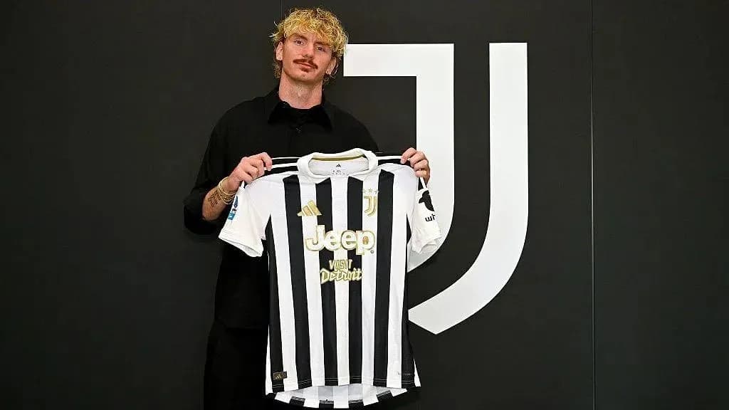 Player holding Juventus jersey at signing event