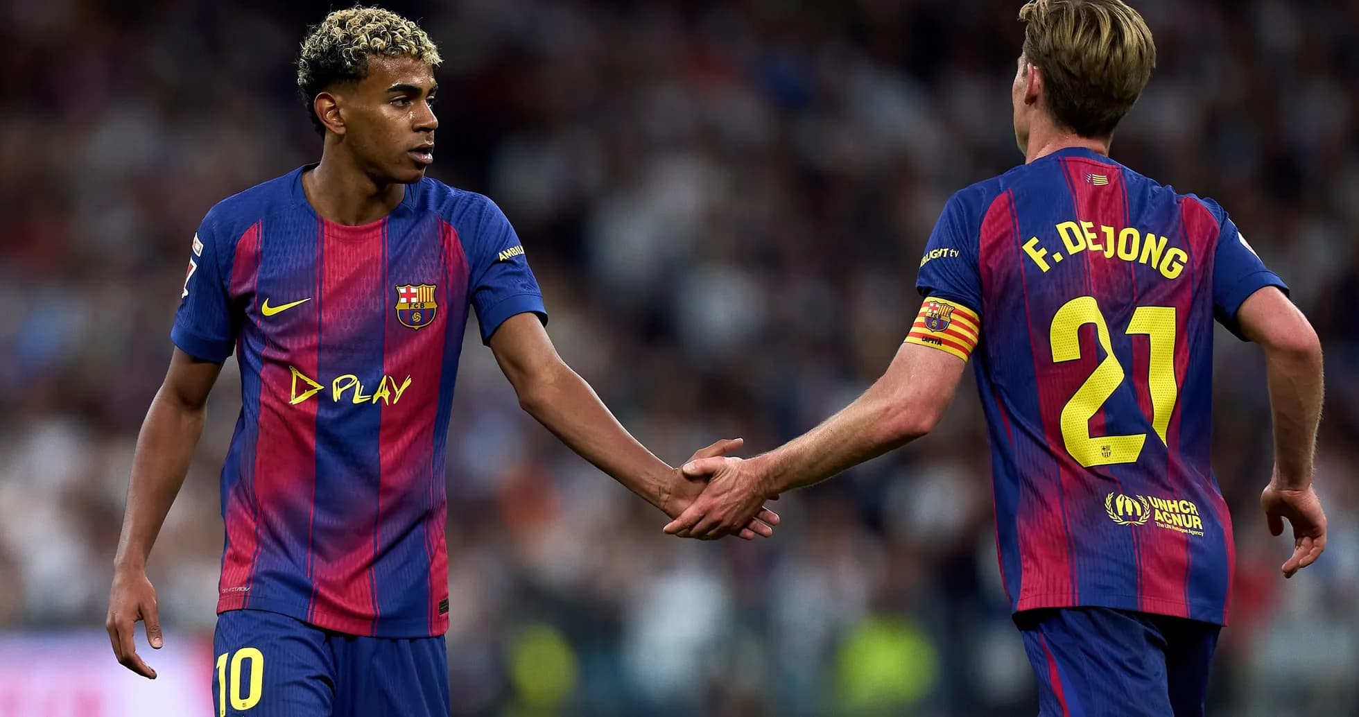Barcelona players exchanging a handshake on field
