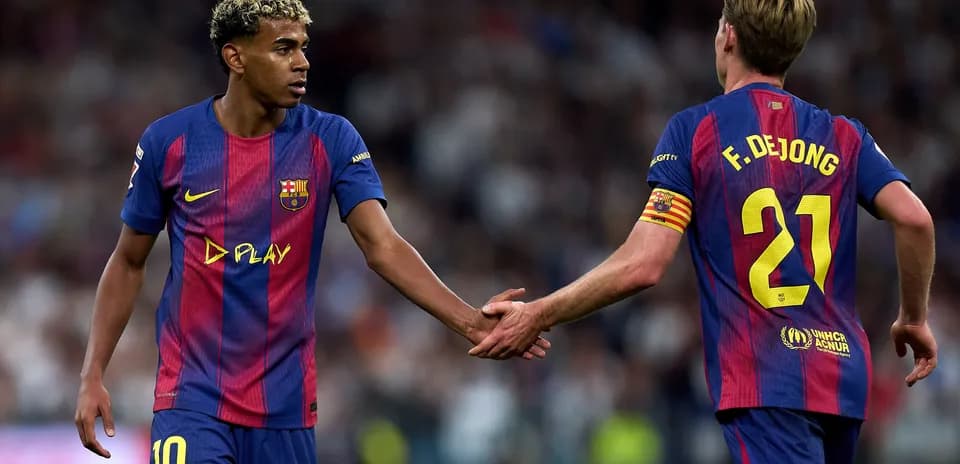 Barcelona players exchanging a handshake on field