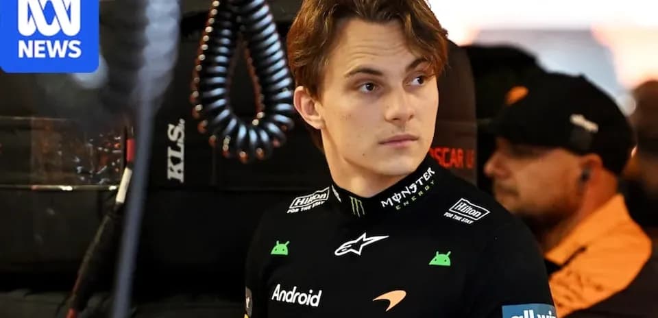 Driver in team uniform in garage area