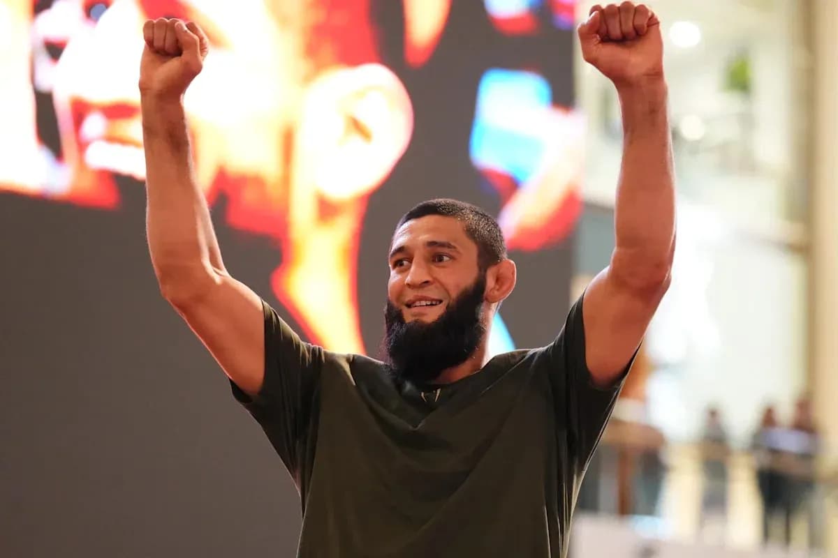 Fighter celebrating with raised arms at event