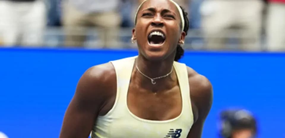 Tennis player celebrating a victory on court