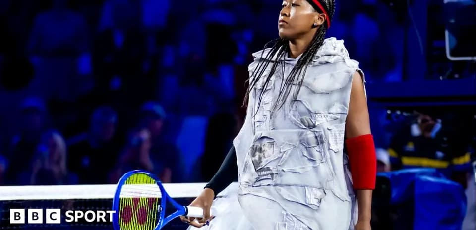 Naomi Osaka walking onto court with tennis racket