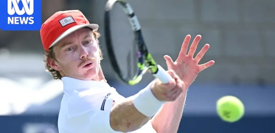 Tennis player hitting a backhand shot during match