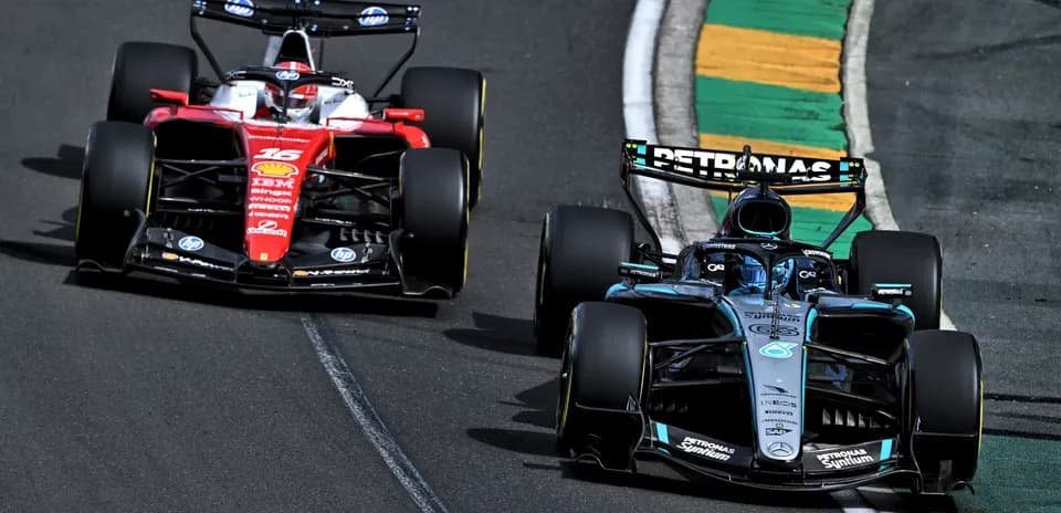 Two Formula 1 cars racing on track during event
