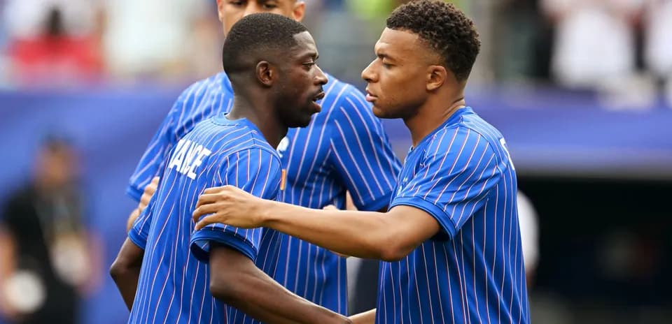 Two players in blue jerseys discussing on the field