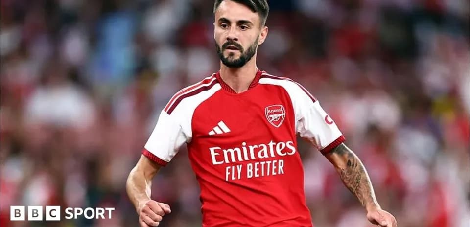 Player wearing Arsenal jersey during match celebration