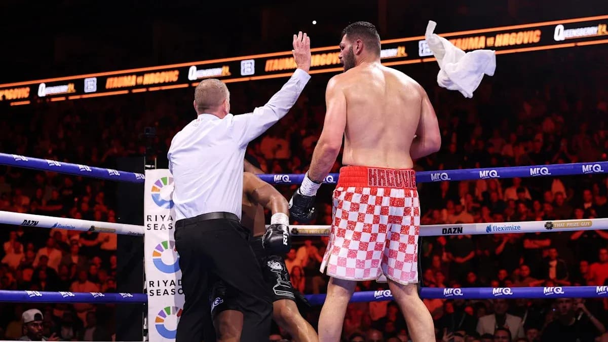 Referee stopping the boxing match in the ring