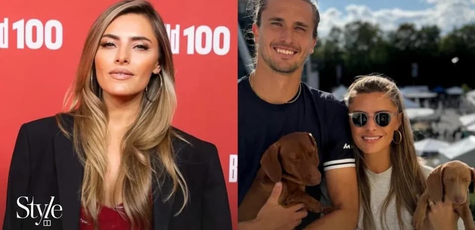 Two people posing with puppies outdoors
