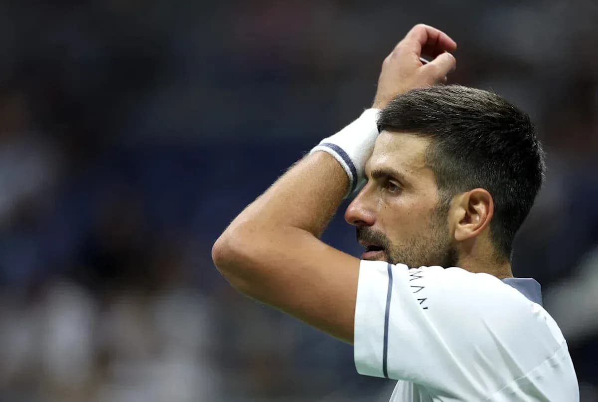 Tennis player with hand on head during match