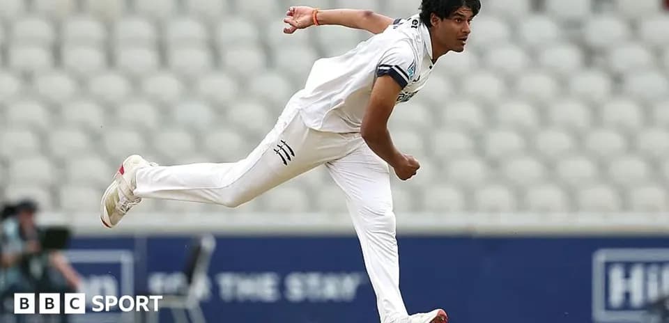 Cricketer bowling during a match on field
