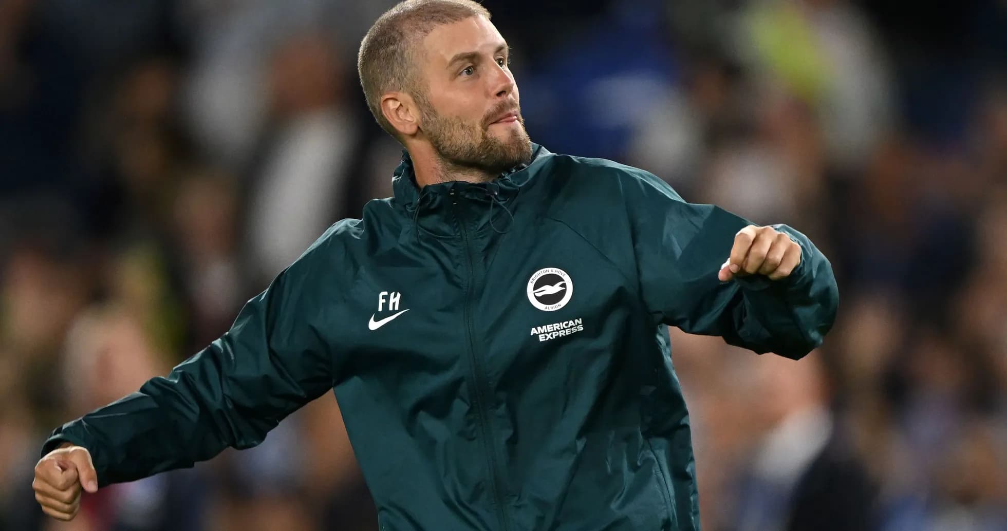 Man celebrating on the sidelines during a match