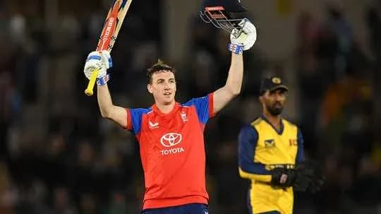 Batsman celebrating century with raised bat and gloves