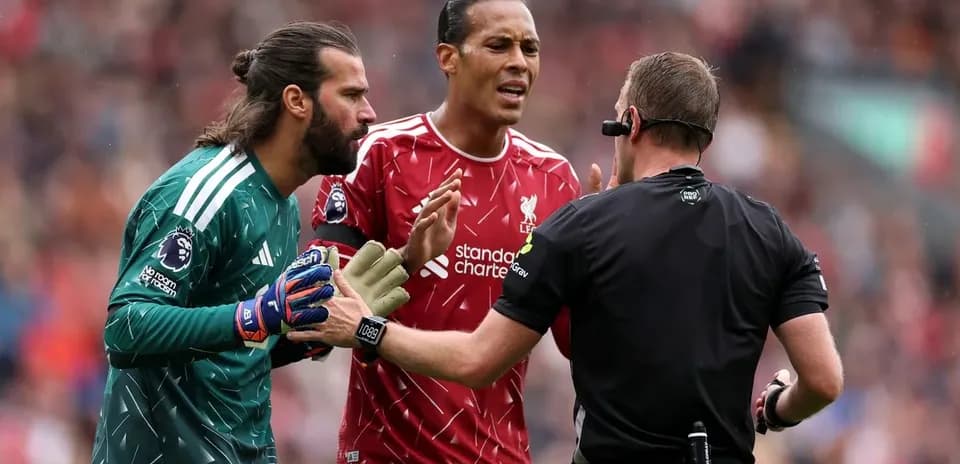 Liverpool players disputing a decision with the referee