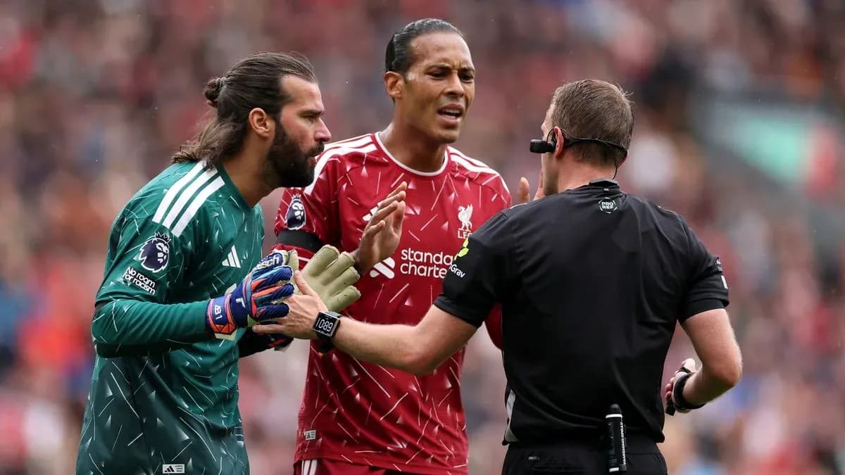 Liverpool players disputing a decision with the referee