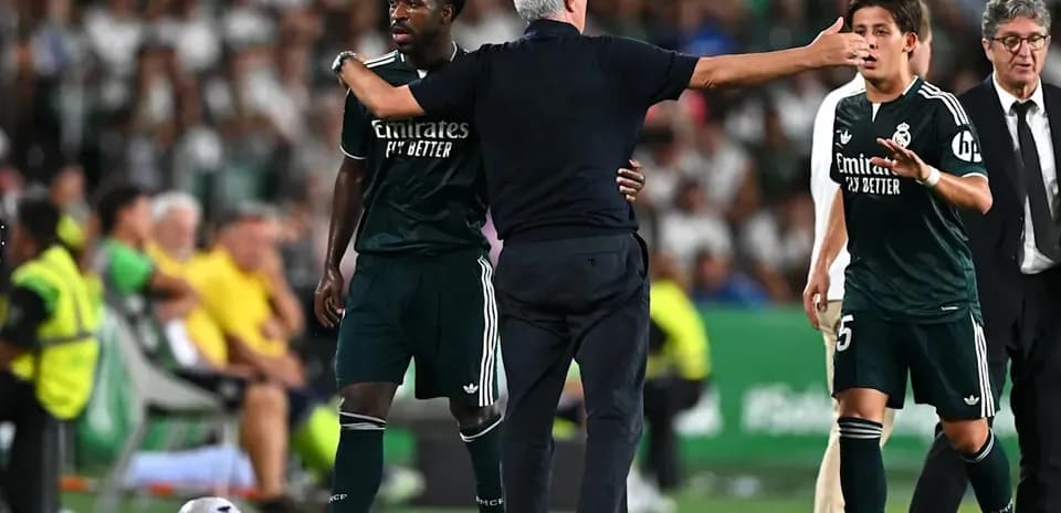 Manager discussing strategy with players on sidelines