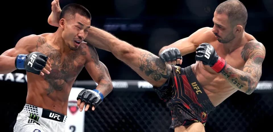 Fighter delivering a high kick in UFC match