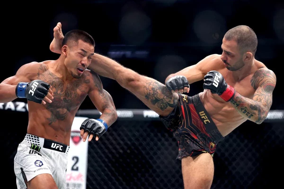 Fighter delivering a high kick in UFC match