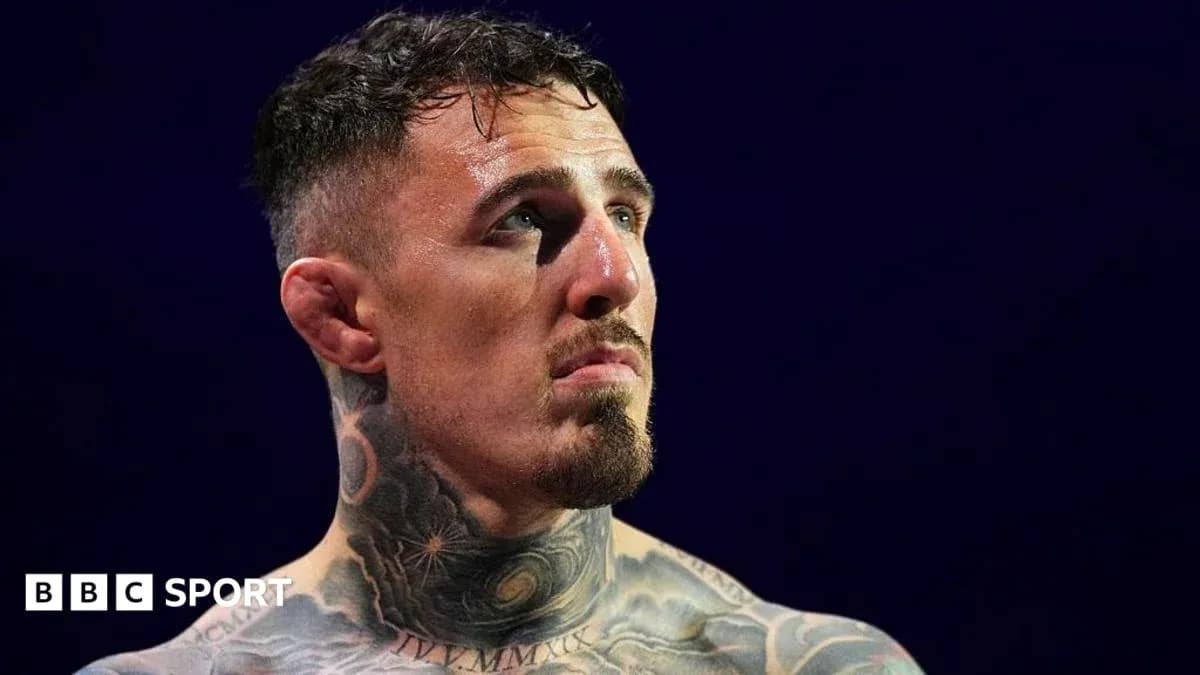 Fighter with tattoos looking up in the ring