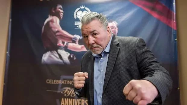 Former boxer posing with fists up at event
