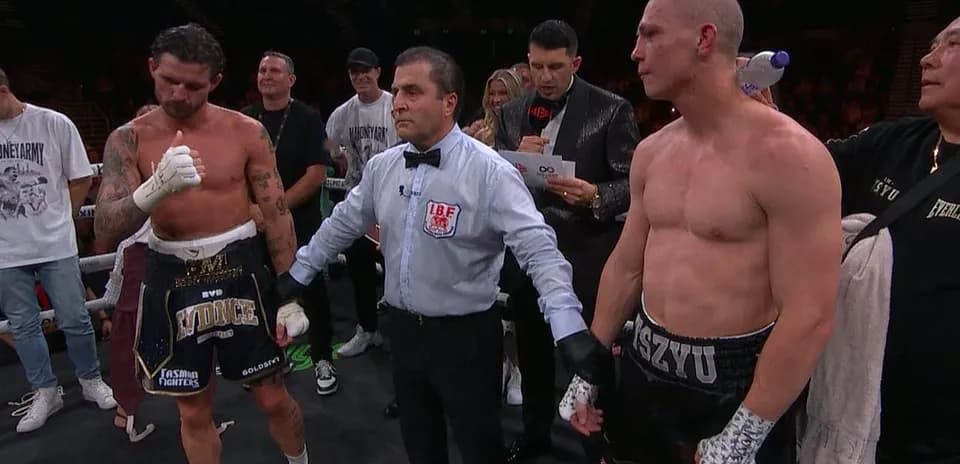 Boxers with referee after match announcement