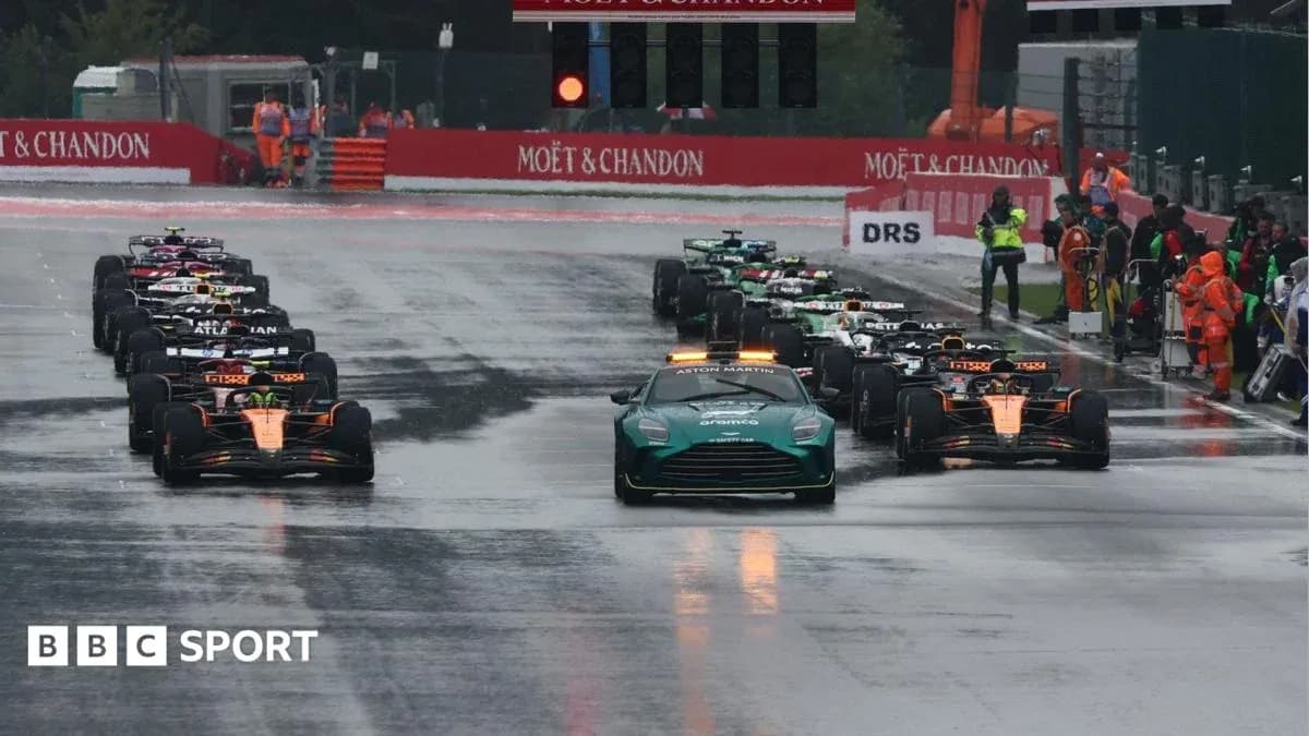 Formula 1 cars lined up under wet conditions