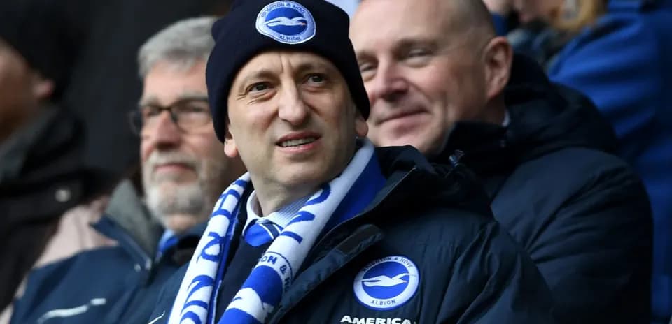 Man wearing Brighton scarf and hat at match