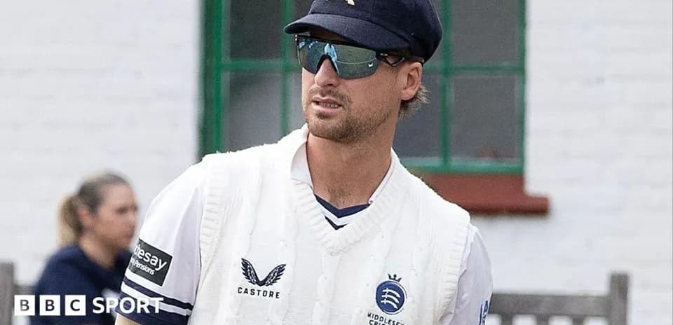 Cricketer in Middlesex kit wearing sunglasses and cap