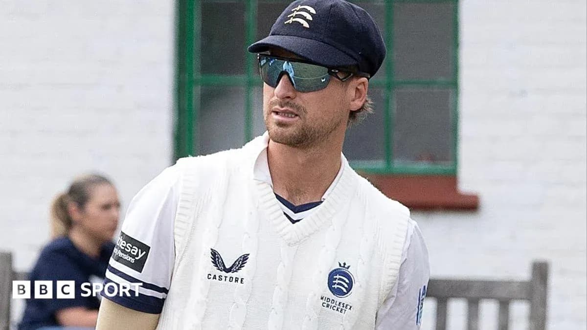 Cricketer in Middlesex kit wearing sunglasses and cap