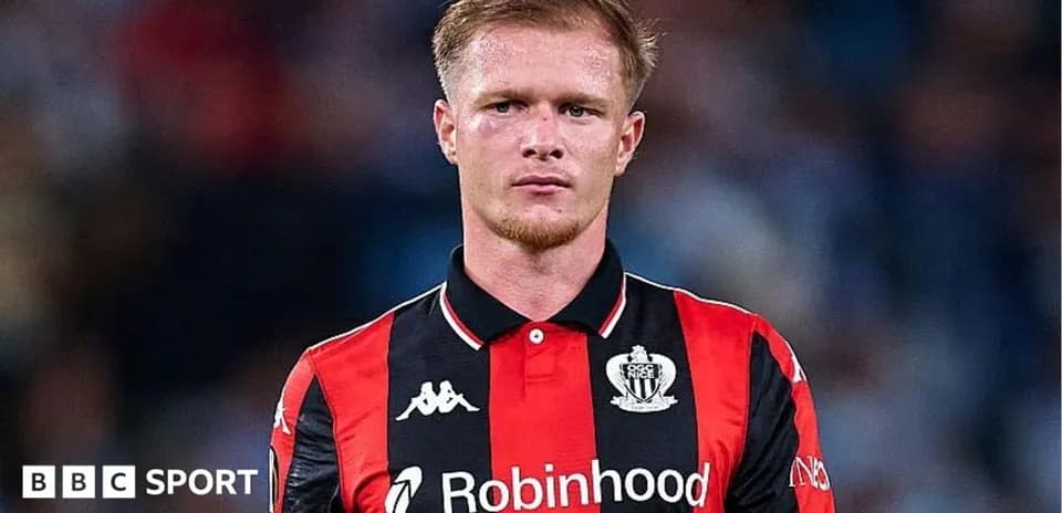 Player in red and black jersey during match
