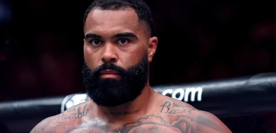 Fighter with tattoos staring intensely before match