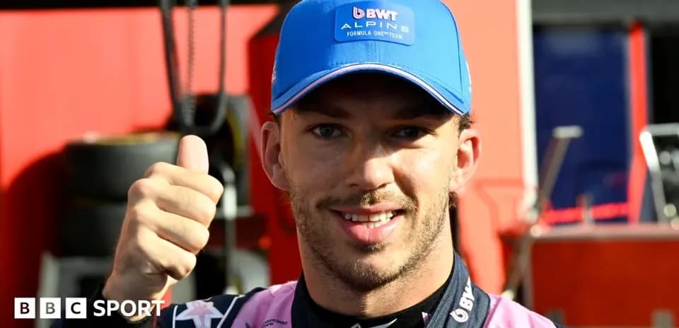 Driver giving thumbs up in team pit area