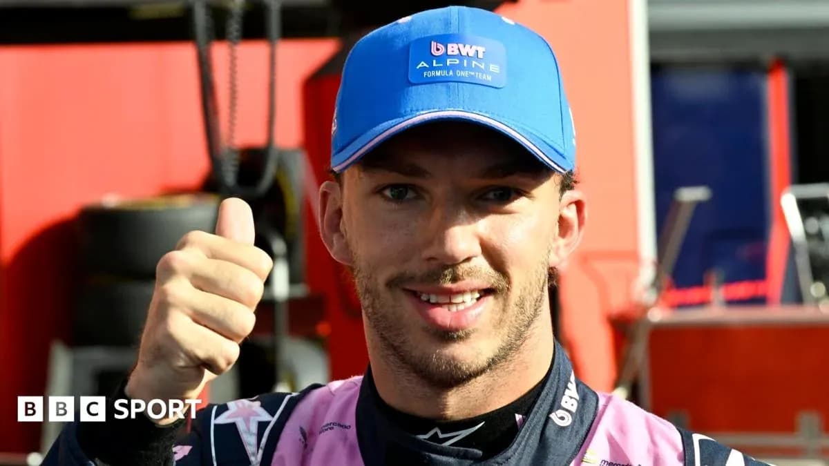 Driver giving thumbs up in team pit area