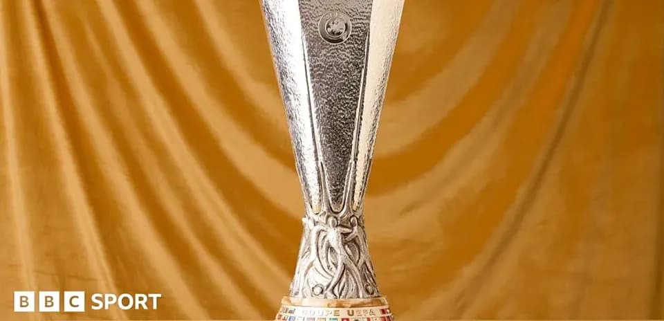 UEFA Cup trophy displayed on golden background
