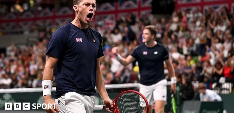 Tennis player celebrating during a match with teammate