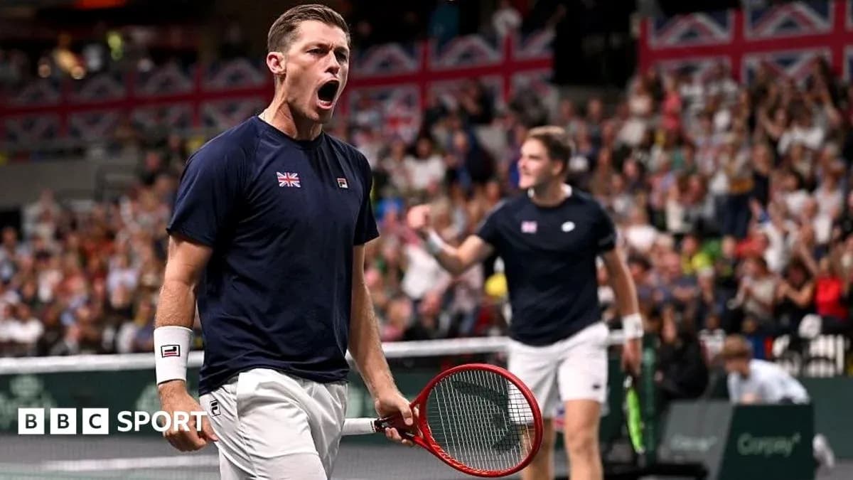Tennis player celebrating during a match with teammate