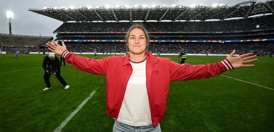 Woman with arms outstretched on rugby field